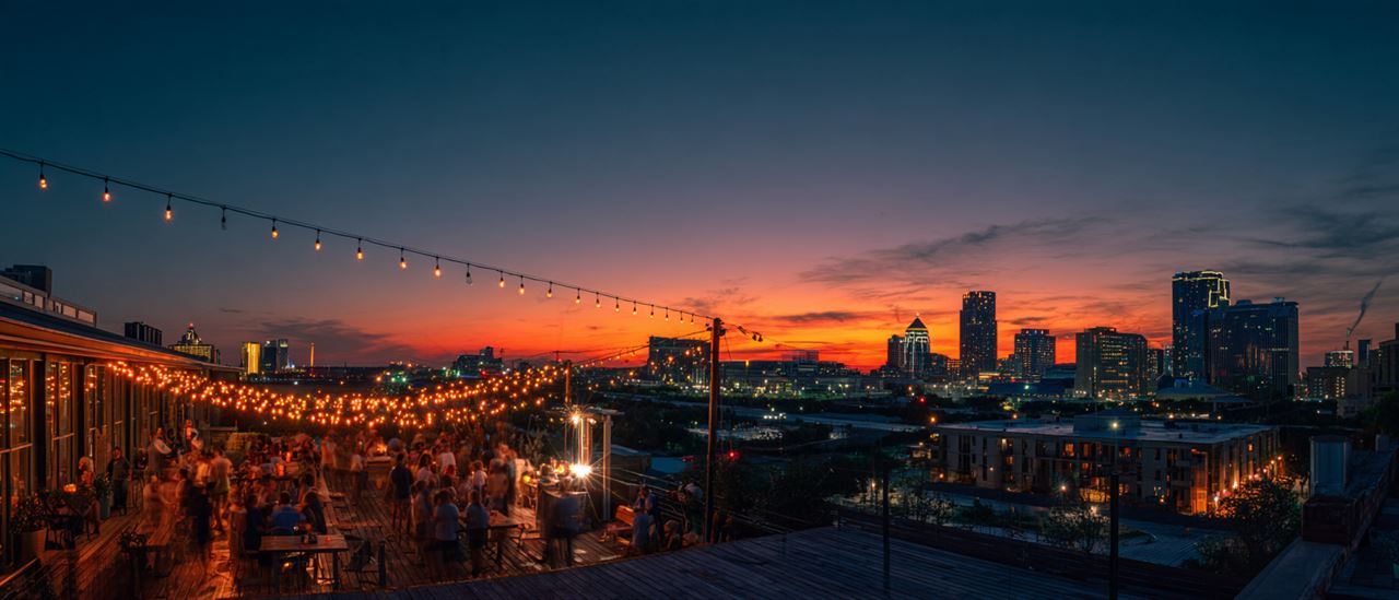 Rooftop party with the Dallas skyline at sunset